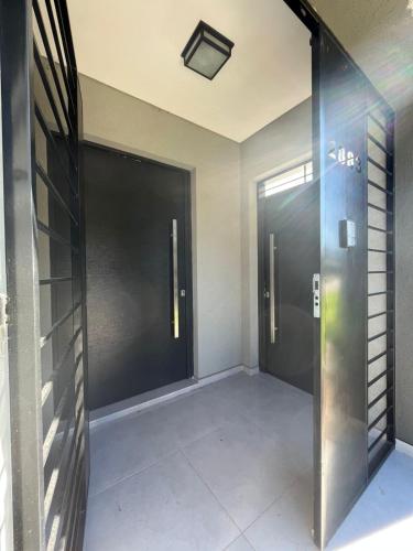 a hallway with two elevators in a building at Casa Granadero Baigorria in Paganini