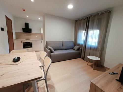 a living room with a table and a couch at Apartamentos Ésera in Santa Liestra y San Quílez