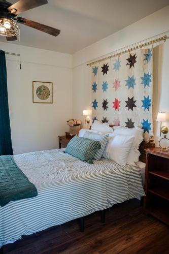 a bedroom with a bed and a wall with stars at The Old Crowe Inn Bed and Breakfast in Fruita