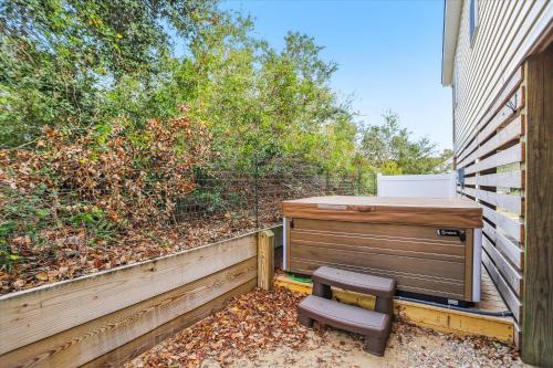 a chair sitting next to a fence next to a building at 5176 - Sandy Bottoms in Kill Devil Hills