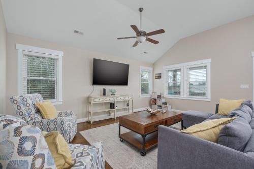 a living room with two couches and a flat screen tv at 5176 - Sandy Bottoms in Kill Devil Hills