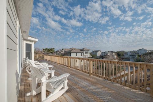 a deck with white chairs on a house at 3941 - Fleur de Duck in Duck