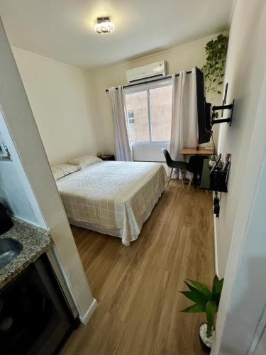 a small bedroom with a bed and a window at Apto no Centro de Porto Alegre in Porto Alegre