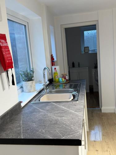 a kitchen with a sink and a counter top at Silver stays, calm coastal stay , close to beach in Gorleston-on-Sea
