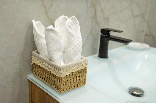 a basket of towels sitting on top of a bathroom sink at Beethoven Suite in Vienna