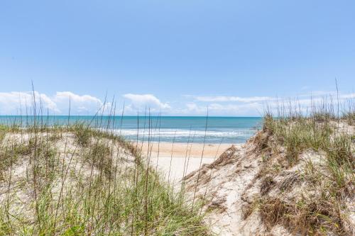 a beach with sand and grass and the ocean at 7847 - Summerset in Frisco