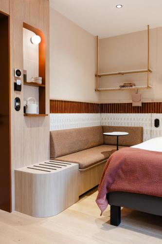 a room with a bed and a bench in a room at AUBERGE FRANKENBOURG in La Vancelle