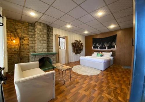 a bedroom with a bed and a fireplace at Acacia Homes in Kuldanna