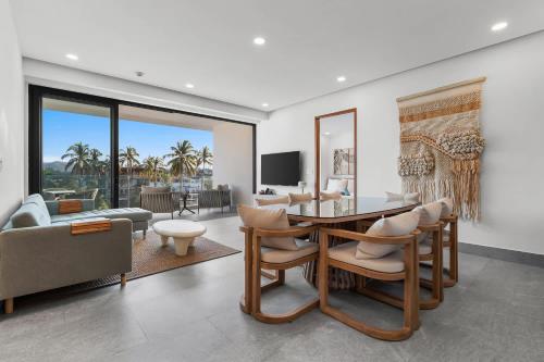 a living room with a table and chairs and a couch at UDARA - Beachfront Condos in Golden Zone with Rooftop in Bucerías