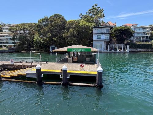 a small dock in the middle of a river at Neutral Bay Stunning Two Bedroom Apartment in Sydney