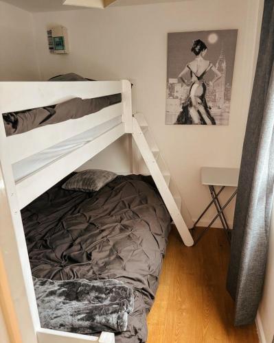 a bunk bed in a small room with a bunk bedutenewayangering at Sun, Sand & Sheppey The Ultimate Escape in Leysdown-on-Sea