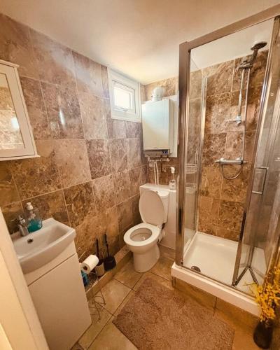 a bathroom with a toilet and a shower and a sink at Sun, Sand & Sheppey The Ultimate Escape in Leysdown-on-Sea