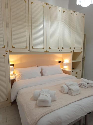 a bedroom with a large bed with towels on it at Colibrì in Bordighera
