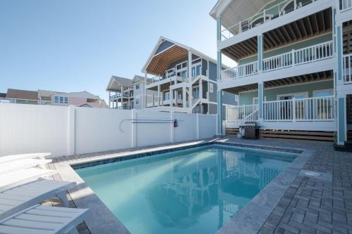 a swimming pool in front of a building at 5700 - La Cebolla in Nags Head