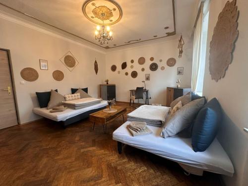 a living room with two couches and a table at Urban Spacious Bright Apartment with DanubeView in Linz