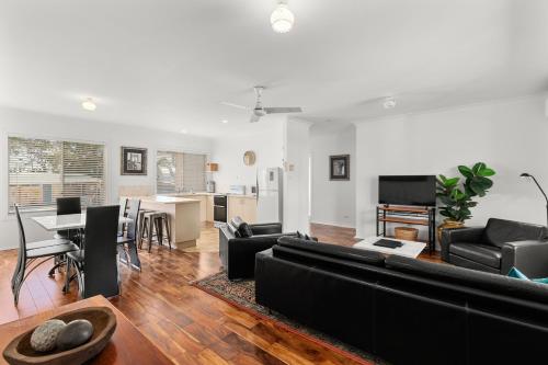 a living room with a couch and a table at Motel Miramar in Nambucca Heads