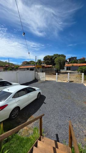 a white car parked in a parking lot at Beira Rio Casa Canastra in Vargem Bonita