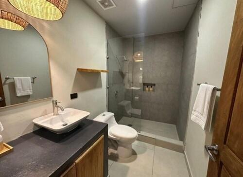 a bathroom with a sink and a toilet and a shower at Litos Hotel y Restaurante in Playa San Blas