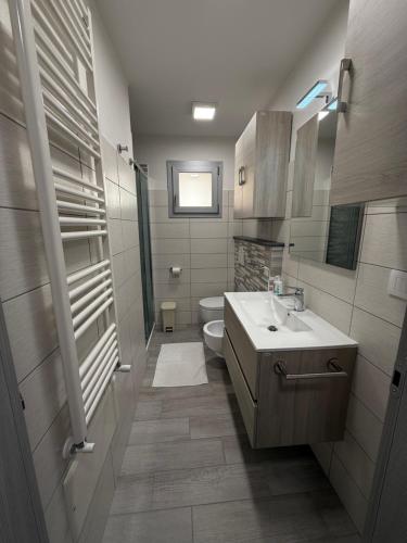 a bathroom with a sink and a toilet at Alba&Tramonto in Arbus