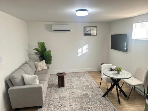 a living room with a couch and a table at Renet Suite in Riverview