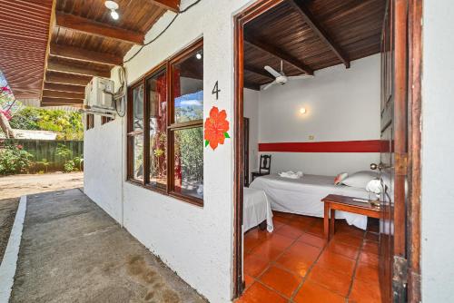 a bedroom in a house with a bed in it at Hotel Hibiscus Cabina 4 in Playa Junquillal