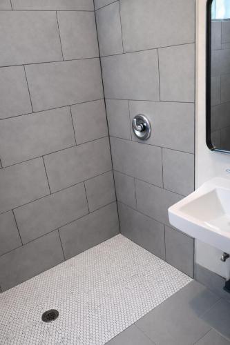 a bathroom with a shower with a sink at Hoover Stay Close to Bus Routes in Los Angeles
