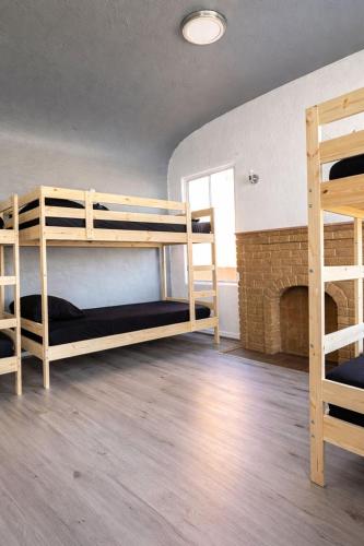 a room with two bunk beds and a fireplace at Hoover Stay Close to Bus Routes in Los Angeles