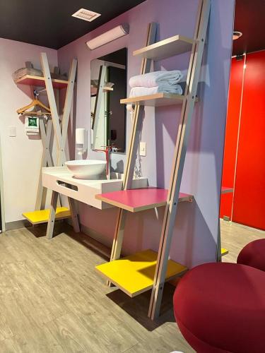 a room with a bathroom with a sink and a mirror at Ibis Styles Mexico Reforma in Mexico City