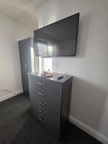 a dresser with a mirror on top of it at Private Cosy Double Bedroom, extremely close to city centre in Manchester