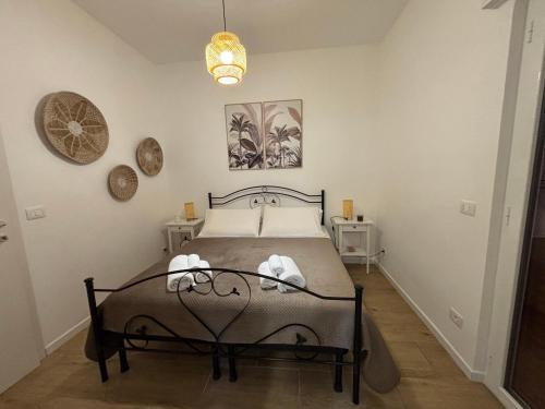 a bedroom with a bed with two towels on it at Dolce Vita in Bari