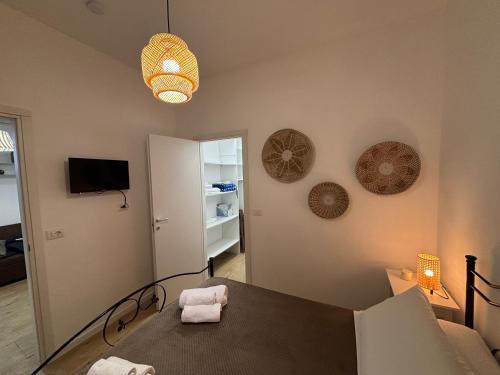 a living room with a table and a room with a tv at Dolce Vita in Bari