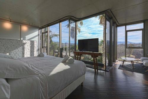 a bedroom with a bed and a flat screen tv at Villa Nola - Diseño Vasco, Lujo y Privacidad in San Sebastián