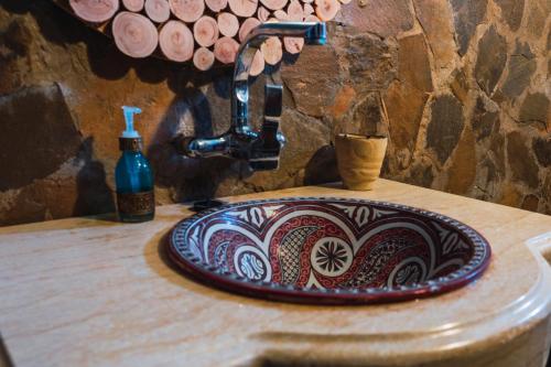 a bathroom counter with a sink and apotion at Dar Duna in Adrouine