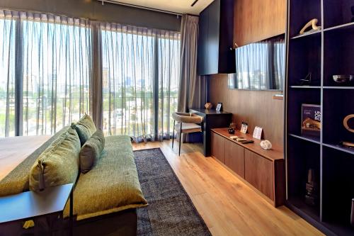 a bedroom with a bed and a large window at Atena Urban Living in Guadalajara