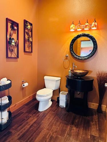 a bathroom with a toilet and a sink and a mirror at Alpine Luxury Chelan Vacation Rentals in Chelan
