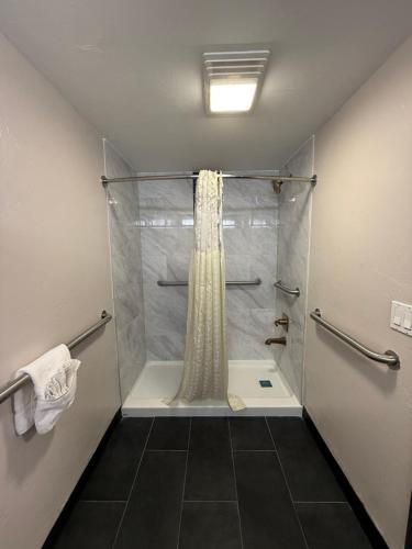 a bathroom with a shower with a shower curtain at Americas Best Value Inn Ponca City in Ponca City