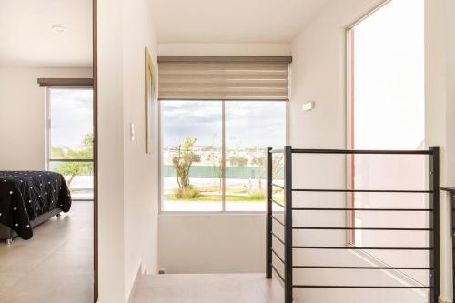 a staircase in a house with a view of the ocean at Quiet and comfortable space in Aguascalientes