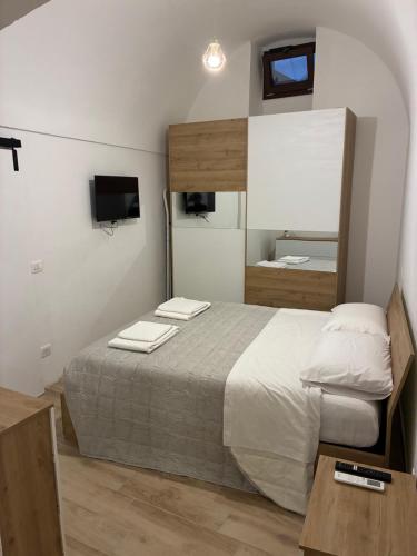 a bedroom with a bed with two towels on it at Vicolo Lungo Apartment in Nardò
