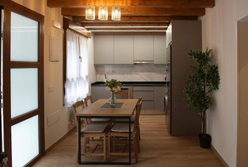 a kitchen and dining room with a table and chairs at Apartamentos Miguel 2 in Onís