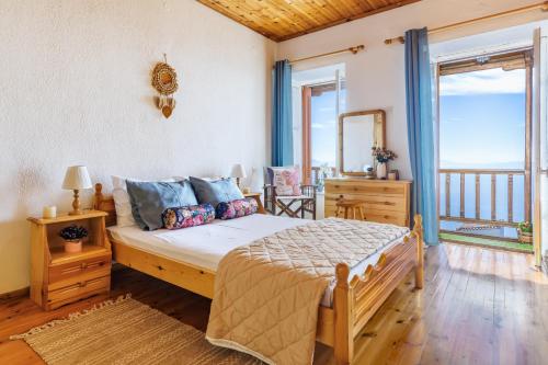 a bedroom with a bed and a balcony at Christys House Skopelos in Glossa