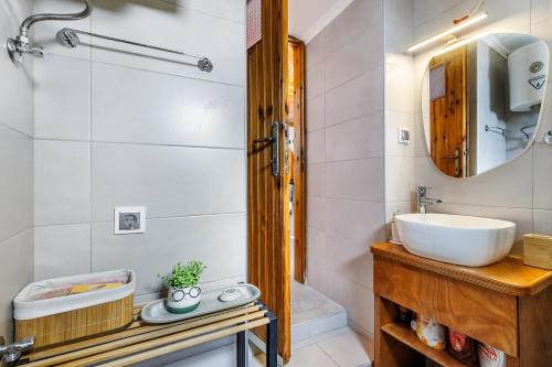 a bathroom with a sink and a mirror at Christys House Skopelos in Glossa