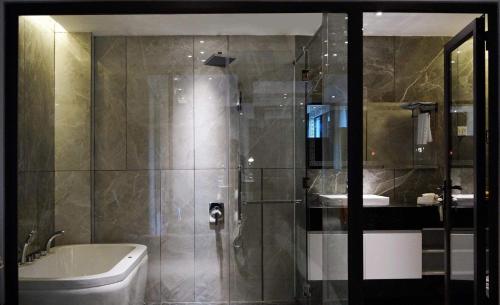 a bathroom with a shower and a toilet and a sink at KP Hotel in Can Tho