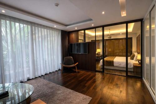 a bedroom with a bed and a desk and a chair at KP Hotel in Can Tho