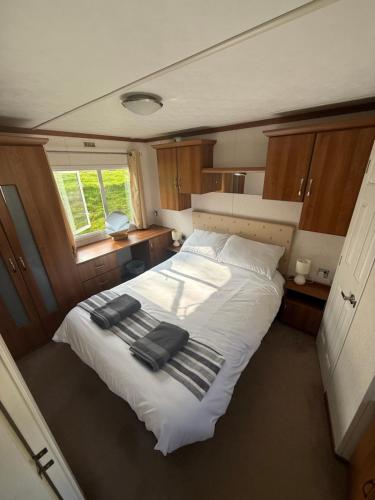 a bedroom with a bed with towels on it at 139 The Ridgeway in Cowes