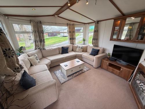 a living room with a couch and a tv at 139 The Ridgeway in Cowes