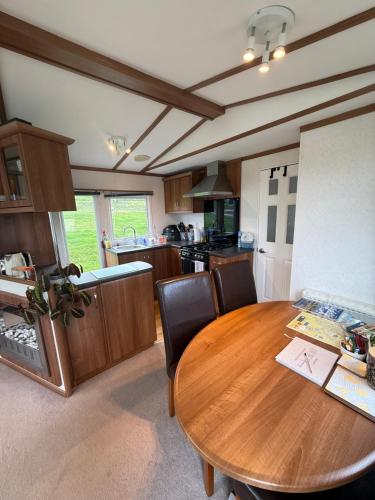 a kitchen with a wooden table and chairs in a kitchen at 139 The Ridgeway in Cowes