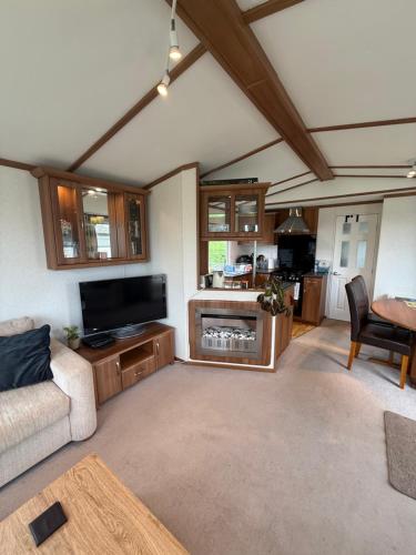 a living room with a couch and a tv at 139 The Ridgeway in Cowes