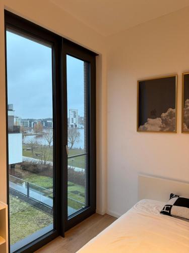 a bedroom with a bed and a large window at Traum - Apartment mit Spa im Haus in Dortmund