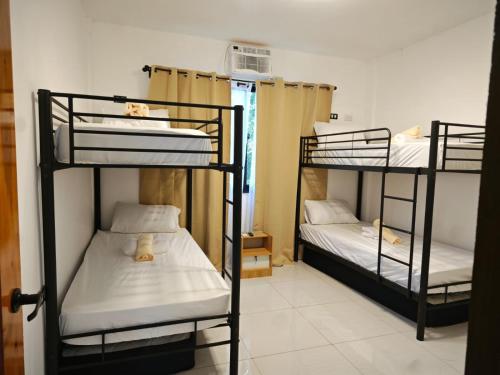 a room with three bunk beds in it at Seanna's Inn in San Juan