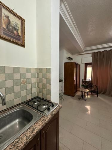 a kitchen with a sink and a stove at Al Majd Hotel in Amman